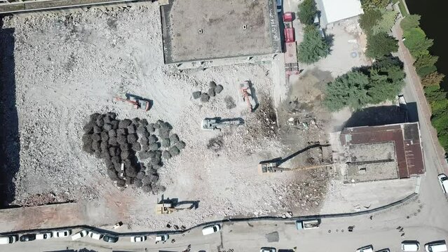 Aerial view of the bulldozer and building demolition at the city center.