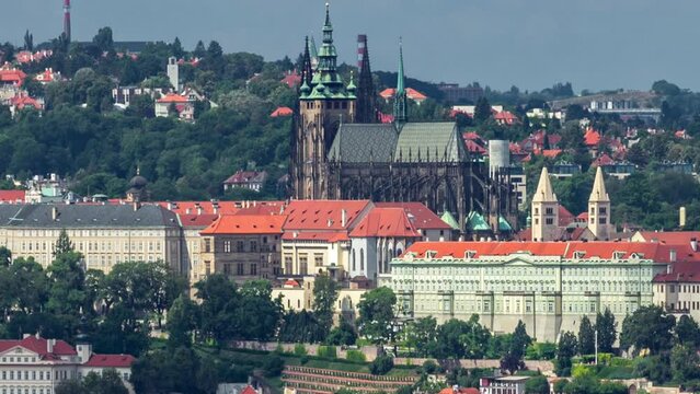 Panoramic view of Prague timelapse from the top of the Vitkov Memorial, Czech Republic. Old Town with red roofs and Prague castle. Cloudy sky at summer day