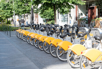 public yellow bicycles parked in the sharing on the street BRUSSELS, BELGIUM 