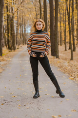 Autumn time, woman in warm clothes, new collection, black- orange sweater and dark outfit