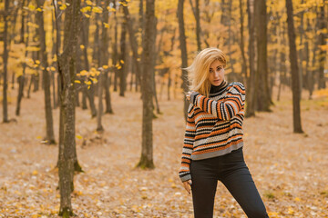 Autumn time, woman in warm clothes, new collection, black- orange sweater and dark outfit