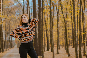 Autumn time, woman in warm clothes, new collection, black- orange sweater and dark outfit
