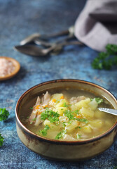A bowl with chicken soup with pasta