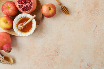 Jewish holiday Rosh Hashanah concept. Honey, apple and pomegranate on stone background. Top view,...