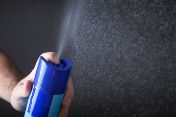  Male hand spraying air freshener.