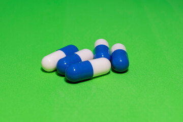medicine capsules manipulated on green background