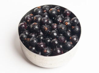 Black currants in a metal bowl