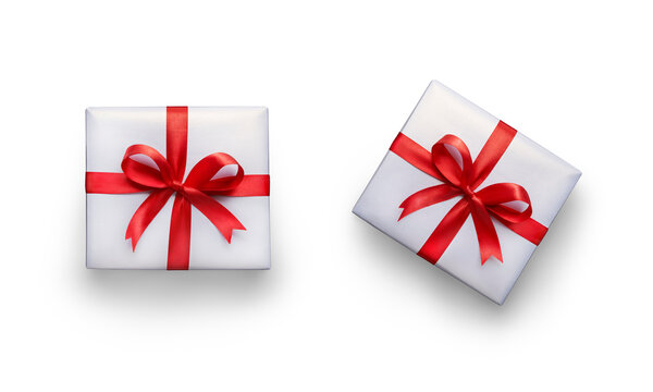 Top view of Christmas, birthday presents wrapped in white paper with red ribbon and bow decoration isolated against a transparent background.