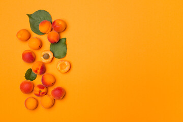Flat lay with ripe apricots on color background, top view