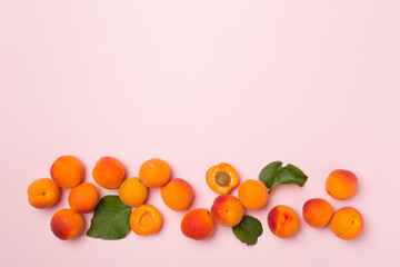 Flat lay with ripe apricots on color background, top view