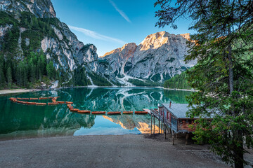 Wooden hut and Lago di Braies in Dolomites at sunrise