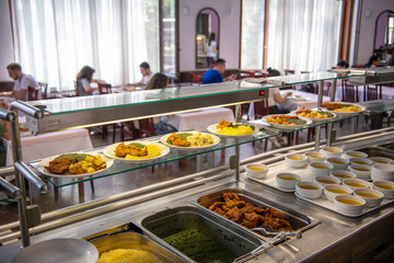 Students being served meal in school canteen. Lunch break. Education people and students eating food meals school cafeteria. Belgrade, Serbia 17.05.2022