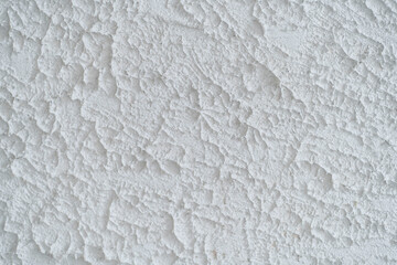 The texture of the stone wall is uneven, white