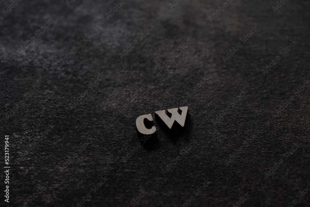 Fototapete the letters c and w above the dark field. initials cw