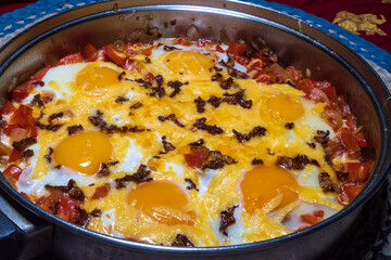 Scrambled eggs with tomatoes mushrooms and cheese