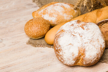 Homemade natural breads. Different kinds of fresh bread as background, perspective view with copy space
