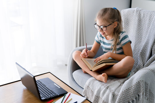 Distance learning at home. School child using laptop for online education in virtual class. Kid talking on video call at lesson. Homeschooling, remote connection, communication, technology lifestyle