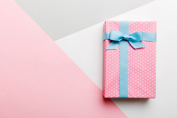 holiday handmade paper present tied blue ribbon bow top view with copy space. Flat lay holiday background. Birthday or christmas present. Christmas gift box concept with copy space