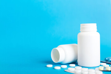 Medicine for treatment HIV infection. Pills and capsules and battle on the table. Different colorful tablets at colored background with copy space
