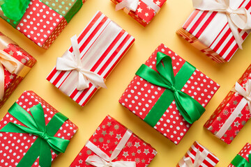 Obraz premium A lot of Christmas gift boxes in colored paper decorated on table, Top view close up. Many present New Year gift