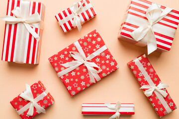 Obraz premium A lot of Christmas gift boxes in colored paper decorated on table, Top view close up. Many present New Year gift