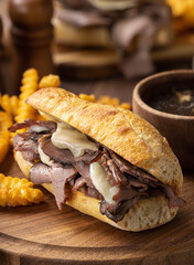 French dip sandwich and bowl of au jus - 523184541