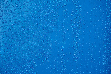 Fototapeta na wymiar Water drops on blue background.
