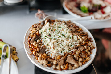A delicious hot dish topped with melted cheese at a wedding buffet.