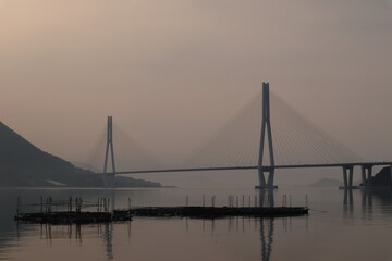 Fototapeta na wymiar 広島県尾道市大三島から望む朝焼けの多々羅大橋