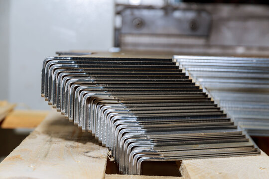 Metal products are bent at 90 degrees on a bending machine stacked on a pallet.