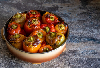 Cooked stuffed peppers minced meat baked in oven, paprika with crust under caps in round baking...