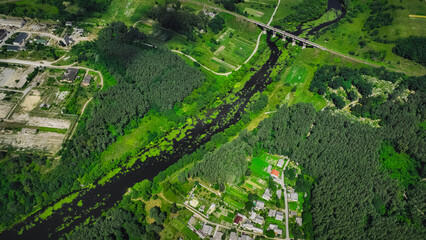 aerial country side summer scenic view composition with abandoned industry territory of plant, suburban space of town, transport roads and bridge, park outdoor environment with green trees