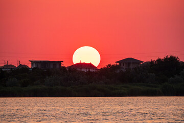 The sun goes down over a lake