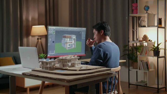 Asian Male Engineer Having A Headache While Designing House On A Desktop At Home. Cyber Games House Design And Decoration
