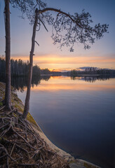 Beautiful sunset in tranquil lake at summer evening in Finland - 523191512