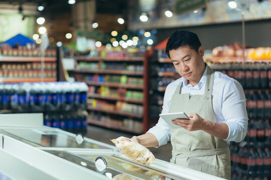 Portrait Of Happy Asian Male Shopkeeper With Tablet