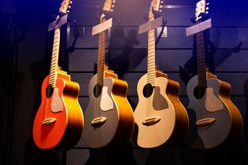 Selective focus to guitar in music shop, many guitars, pop rock artist song music and entertainment instrument.