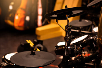 Fototapeta na wymiar Selective focus to electronic cymbals of electronic drum set in music room. The concept of electronic musical instrument.