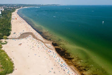 Baltic coast, people having bath in the sea and in the Oliwski stream mouth to the sea during hot summertime weekend