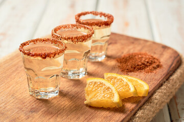 Mexican mezcal shot with chili pepper and orange