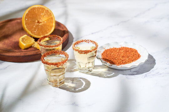 Mexican mezcal shot with chili pepper and orange
