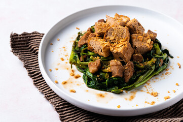Adobong Kangkong (Water spinach) topped with fried tofu and pork sprinkled with toasted garlic bits