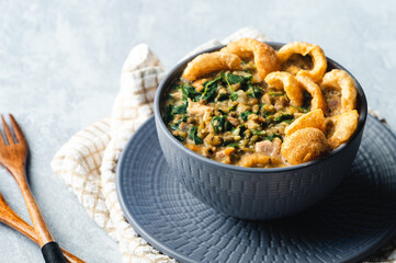 Ginisang Munggo at Chicharon is a famous Filipino dish and is a delicious mung bean stew flavored with crispy pork cracklings.