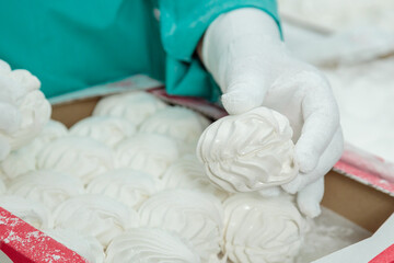 Fototapeta na wymiar Confectionery factory. Production of confectionery products. Packaging of marshmallows
