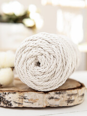 Cotton ropes for creativity and cotton flower on wooden background. Yarn bobbin. Macrame. Soft focus