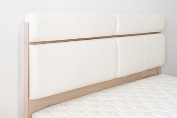 New wooden bed with  leather bed headboard and mattress.