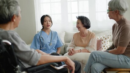 Group of asian senior people listening to young nurse.Psychological support group for elderly therapy session in a community centre. Group therapy in session sitting in a circle in a nursing home.