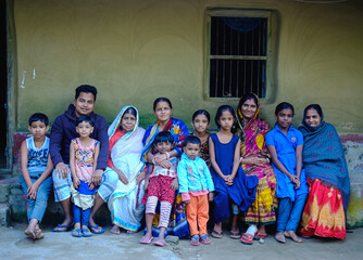 South asian combined family photo, a group of Bangladeshi hindu religious village people sitting outside home