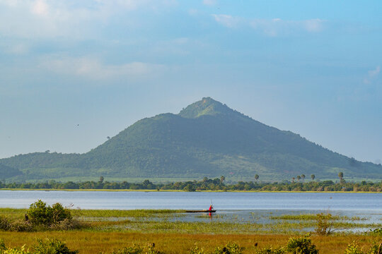 Kampot. Cambodia. Kampot Province. Around Kampot. Fisherman, in the background Mount Bokor