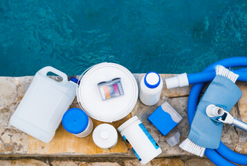 High angle view of equipment for testing the quality of pool water, vacuum cleaner and chemical...